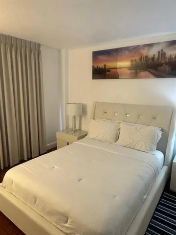 a large white bed in a small room