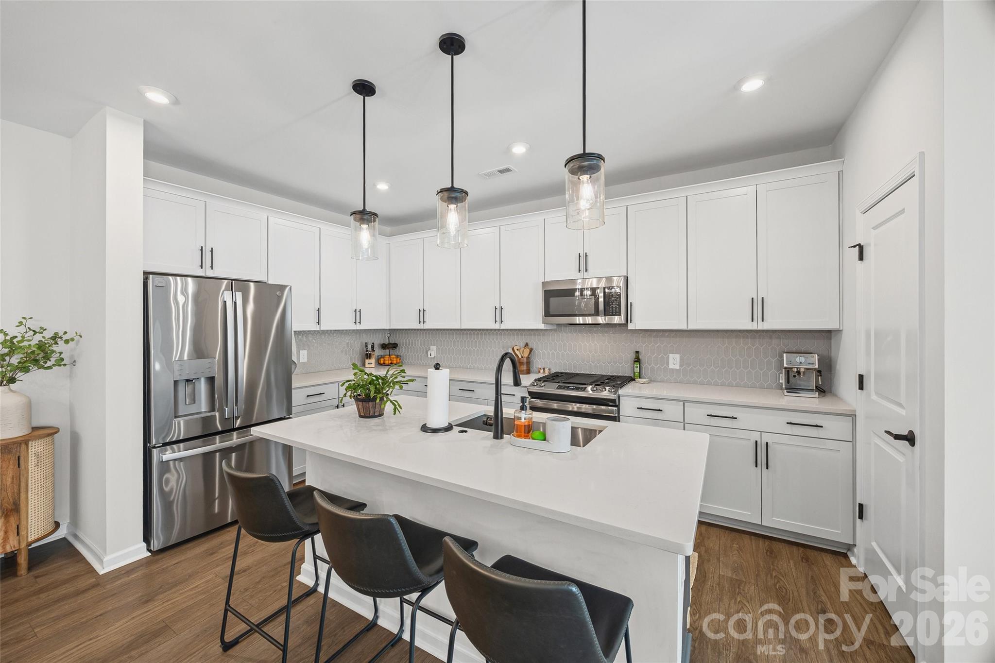 285 Brooks Springs Drive Fort Mill, SC 29708 - Photo 10 of 28 a kitchen with stainless steel appliances a stove a sink a refrigerator a center island and chairs