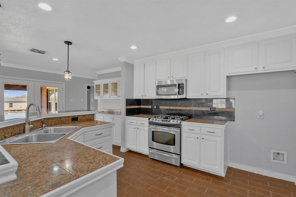 319 Hawk Ridge Decatur, TX 76234 - Photo 15 of 38 a kitchen that has a sink and a stove in it
