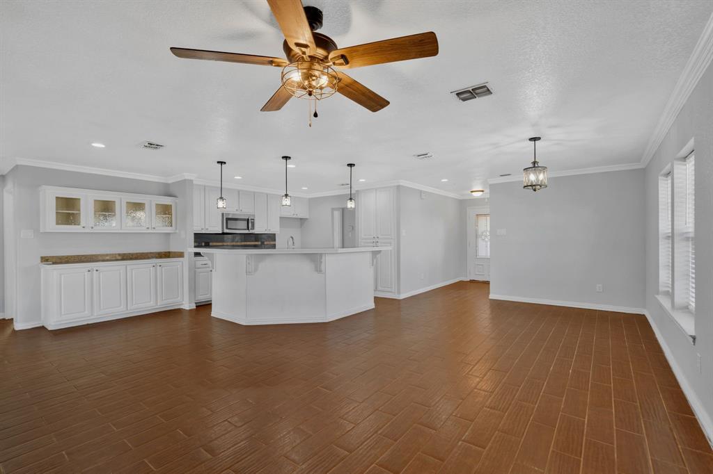 319 Hawk Ridge Decatur, TX 76234 - Photo 9 of 38 a view of a kitchen with a kitchen island wooden floor and a ceiling fan