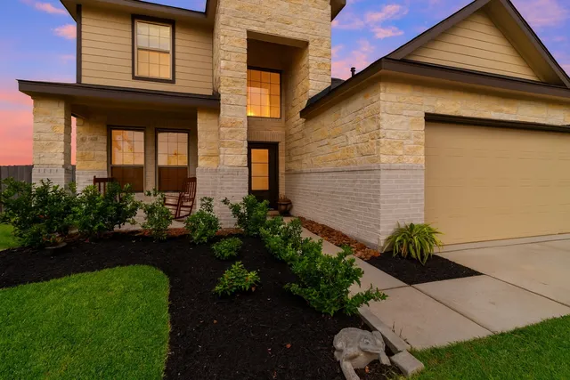 a front view of a house with a garden