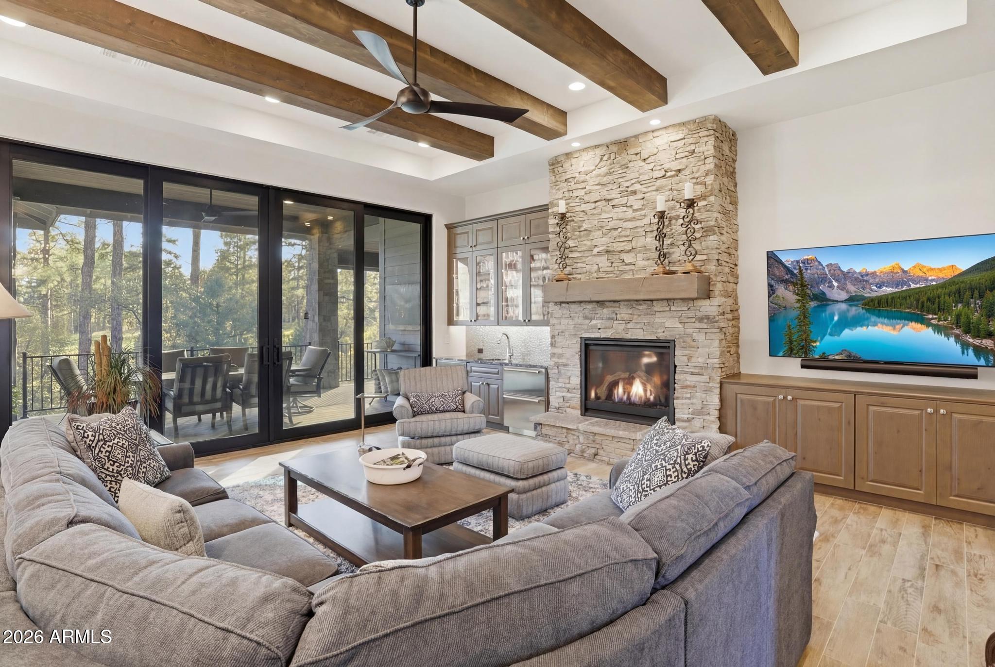 2207 East Filaree Circle Payson, AZ 85541 - Photo 4 of 38 a living room with furniture a fireplace and a flat screen tv