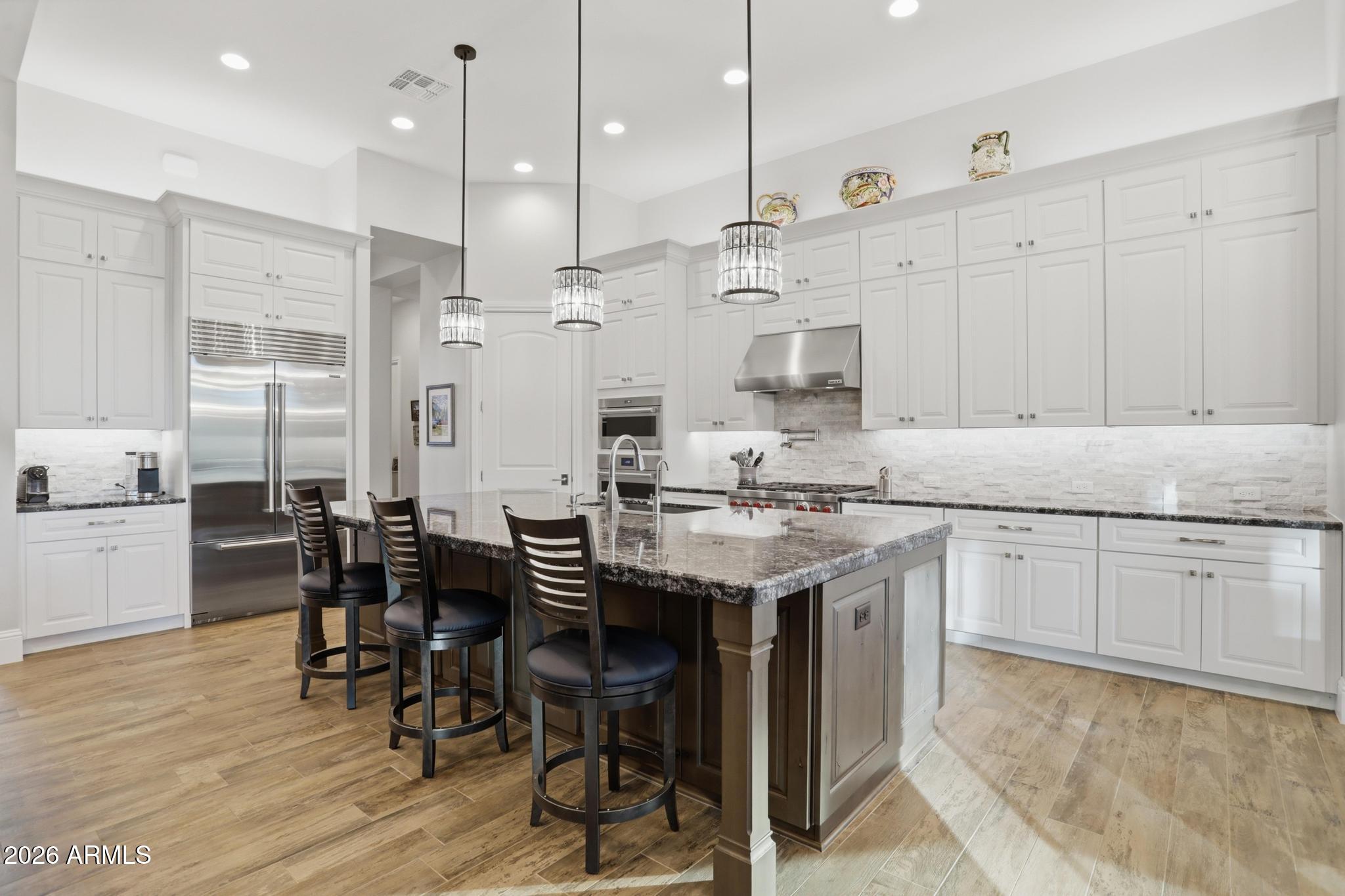 2207 East Filaree Circle Payson, AZ 85541 - Photo 6 of 38 a kitchen with stainless steel appliances granite countertop a table chairs stove a sink and white cabinets