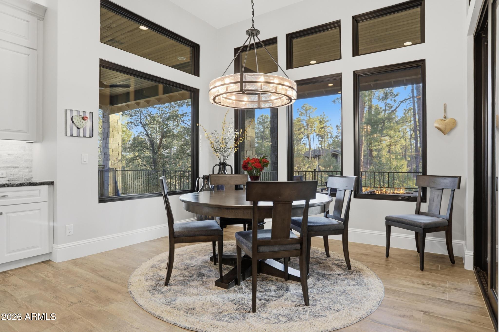 2207 East Filaree Circle Payson, AZ 85541 - Photo 8 of 38 a dining room with furniture a chandelier and wooden floor