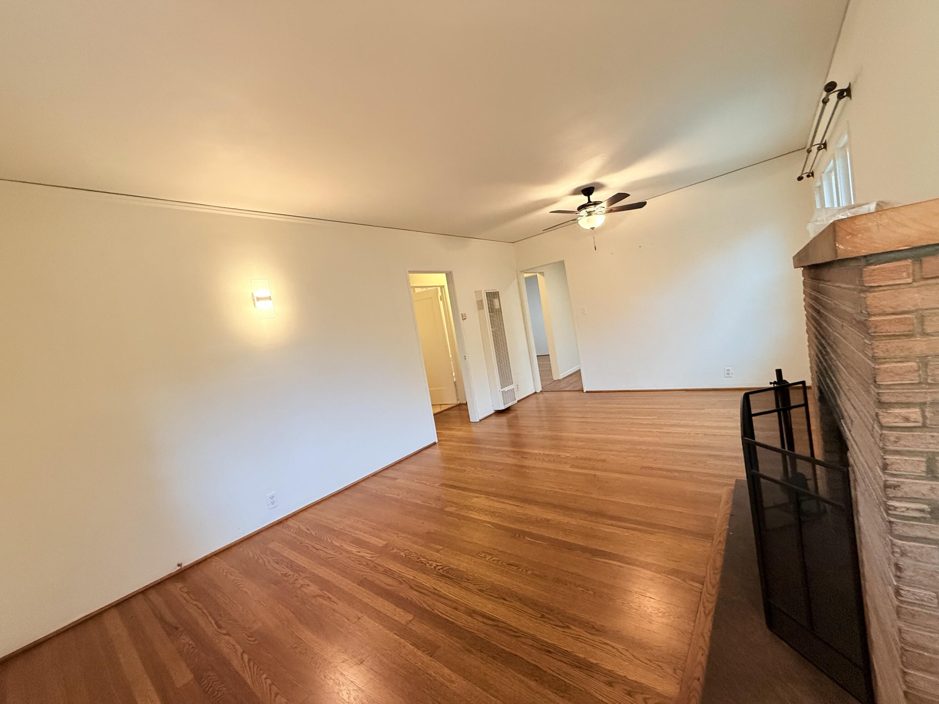 1411 Gillespie Street Santa Barbara, CA 93101 - Photo 7 of 26 a view of a room with wooden floor and a ceiling fan