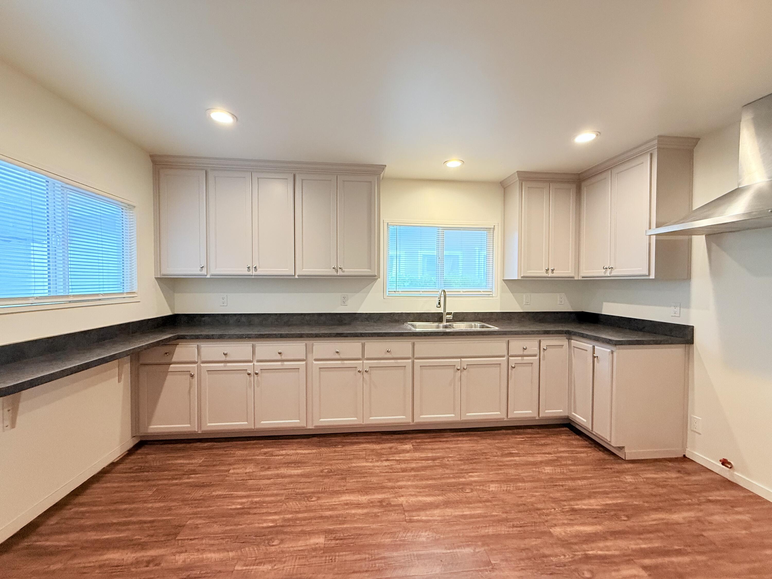1411 Gillespie Street Santa Barbara, CA 93101 - Photo 8 of 26 a kitchen with granite countertop a sink cabinets and wooden floor