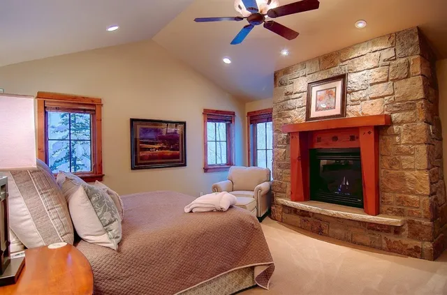 a bedroom with a bed and a fireplace