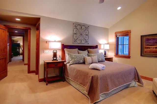 a bedroom with a large bed and a chandelier