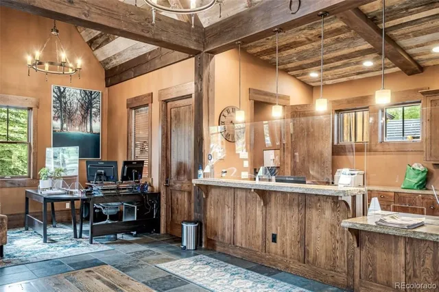 a view of a kitchen with kitchen island granite countertop a sink and a counter top space