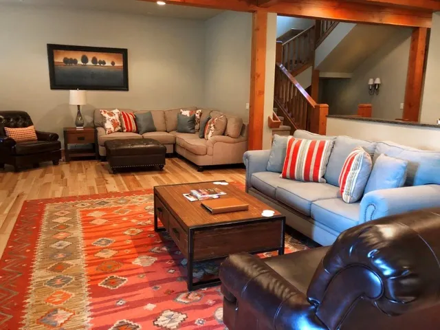 a living room with furniture and a mirror