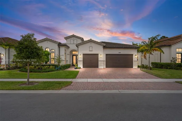 a front view of a house with a yard and a garage