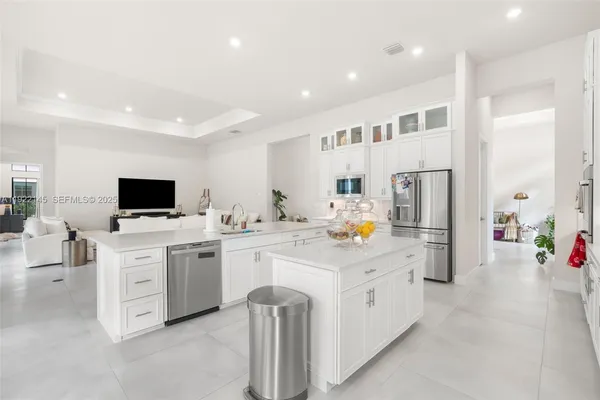 a kitchen with counter and chairs
