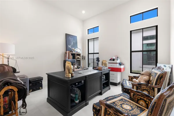 a bed sitting in a spacious bedroom next to a window