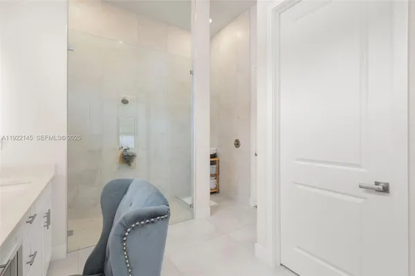 a bathroom with a bathtub sink vanity and mirror