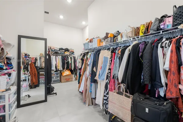 a bedroom with a bed couch and window