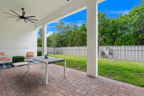 a view of a porch with chairs and backyard