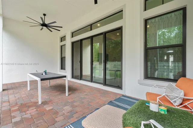 a view of a house with backyard and porch