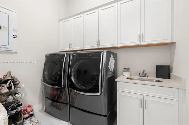 an aerial view of a residential houses with outdoor space and street view
