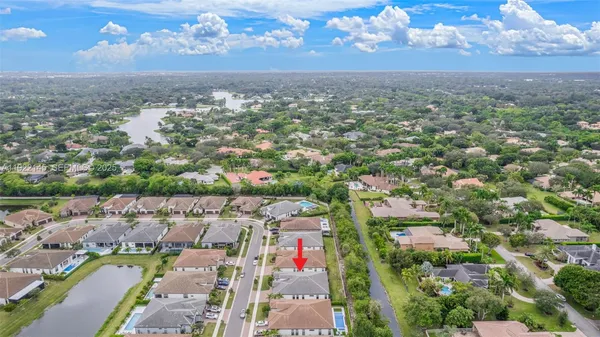 an aerial view of a house with a yard