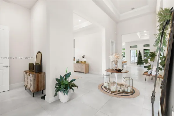 a living room with furniture fireplace and a large window