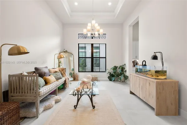 a living room with furniture and a chandelier