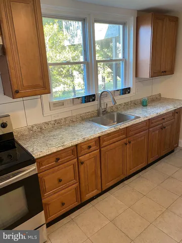 a kitchen with granite countertop a sink and a window