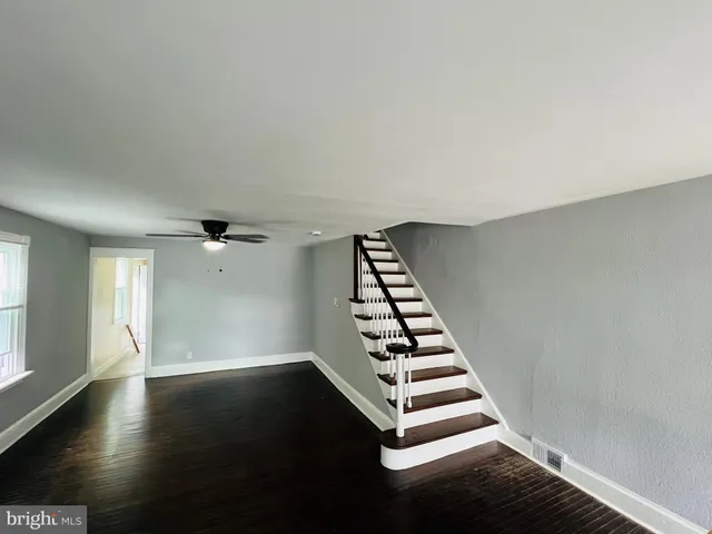 an empty room with windows and chandeliers