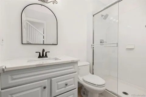 a bathroom with a toilet a sink and shower