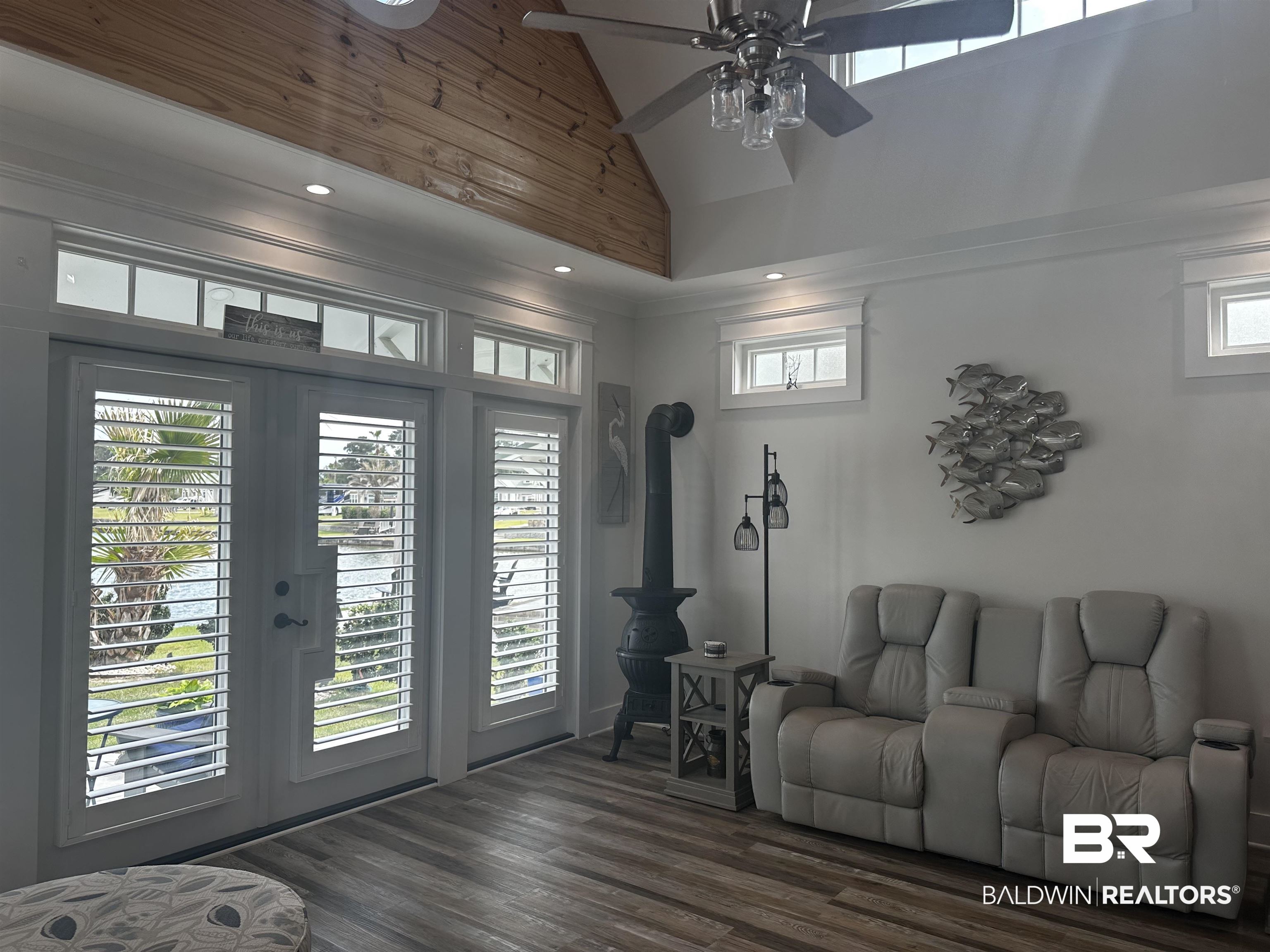 28058 Migratory Way, Unit 100 Elberta, AL 36530 - Photo 39 of 83 Living room featuring french doors, dark wood-type flooring, crown molding, high vaulted ceiling, and ceiling fan