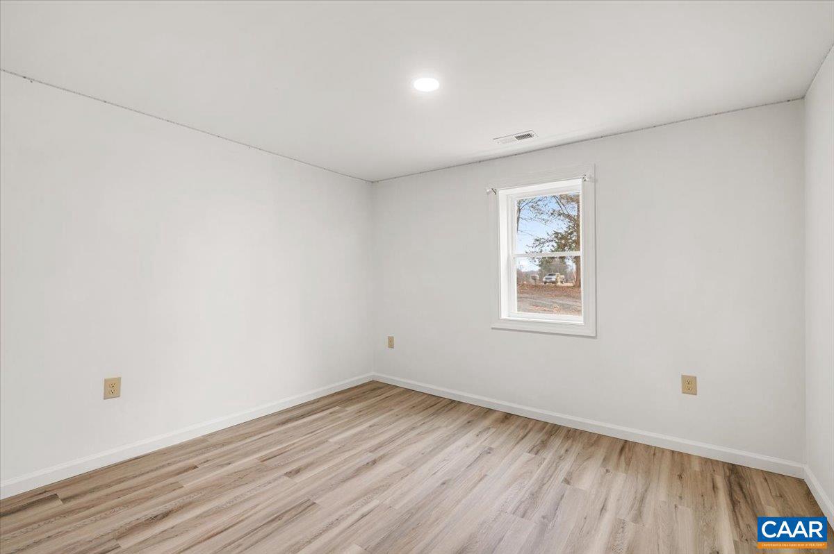 662 Celt Road Stanardsville, VA 22973 - Photo 11 of 22 an empty room with wooden floor and windows