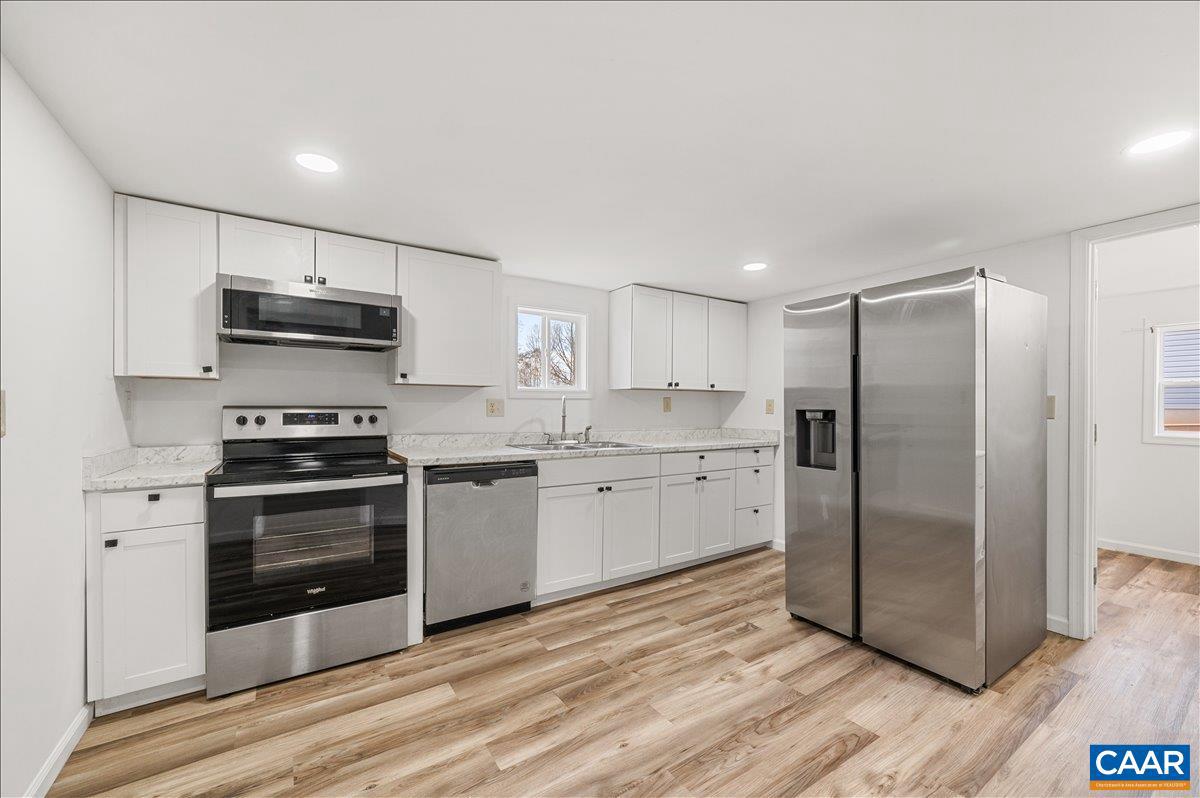 662 Celt Road Stanardsville, VA 22973 - Photo 13 of 22 a kitchen with stainless steel appliances granite countertop a stove a refrigerator and a microwave