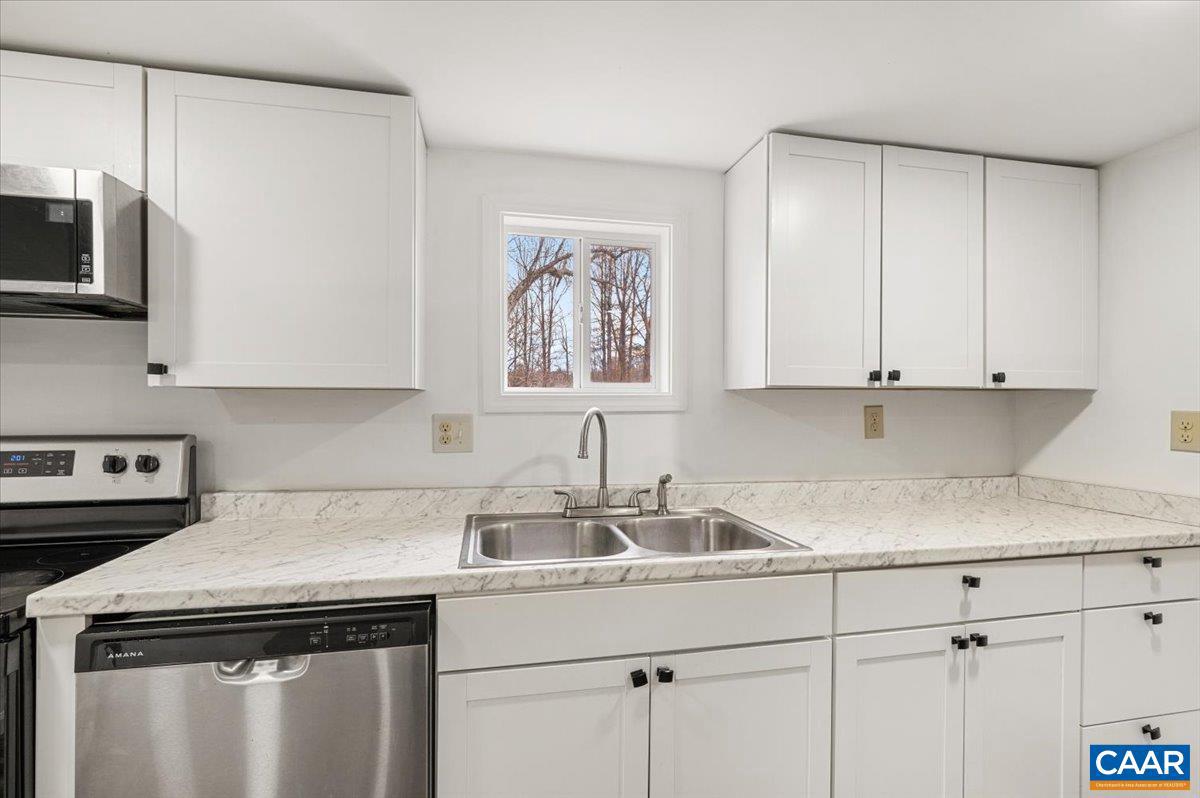 662 Celt Road Stanardsville, VA 22973 - Photo 15 of 22 a kitchen with stainless steel appliances granite countertop a sink a stove and cabinets
