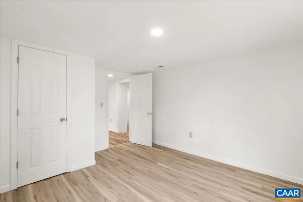 a view of an empty room and wooden floor