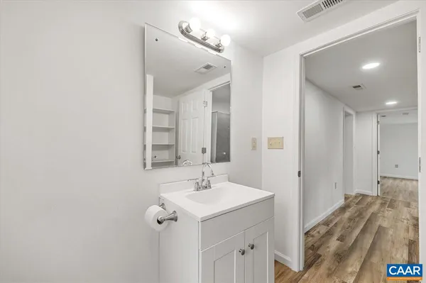 a spacious bathroom with a sink and a mirror