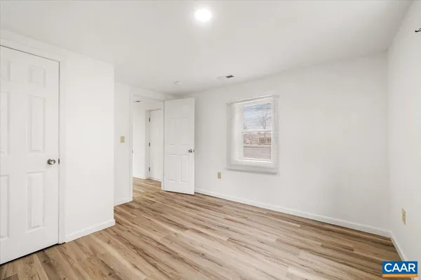 a view of a room with wooden floor and white walls