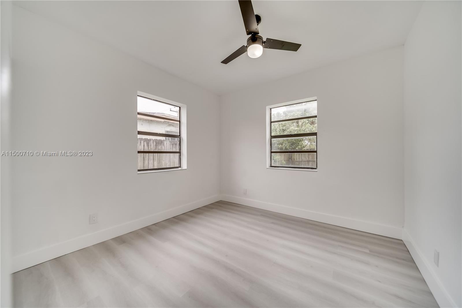 6126 Southwest 19th Street, Unit E Miramar, FL 33023 - Photo 12 of 26 an empty room with windows and ceiling fan