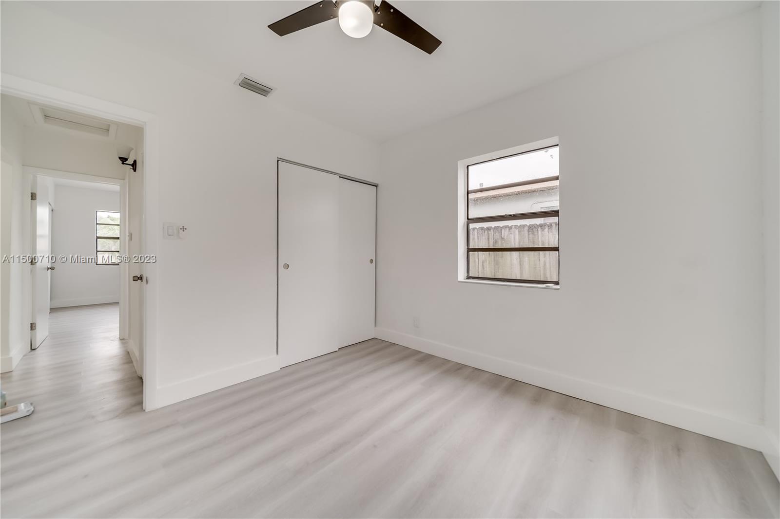 6126 Southwest 19th Street, Unit E Miramar, FL 33023 - Photo 13 of 26 wooden floor in an empty room with a window