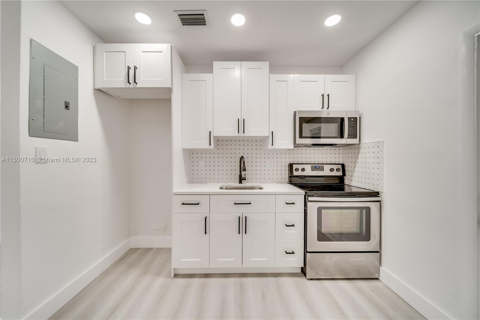 6126 Southwest 19th Street, Unit E Miramar, FL 33023 - Photo 3 of 26 a kitchen with stainless steel appliances granite countertop a stove a sink and a refrigerator