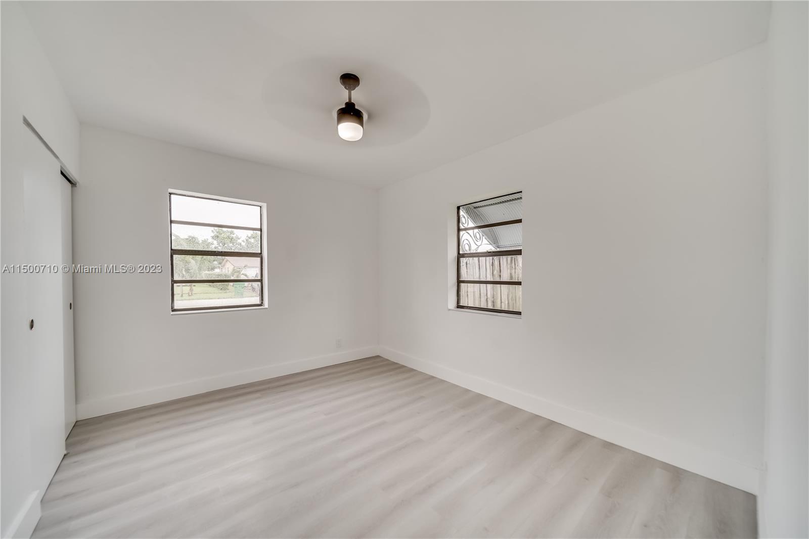 6126 Southwest 19th Street, Unit E Miramar, FL 33023 - Photo 10 of 26 an empty room with windows and closet