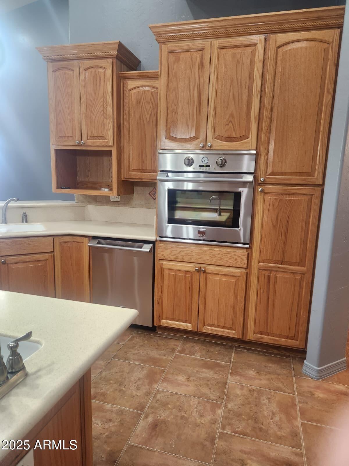1766 East Golf Course Road Douglas, AZ 85607 - Photo 11 of 29 a kitchen with stainless steel appliances granite countertop a refrigerator a stove and a sink