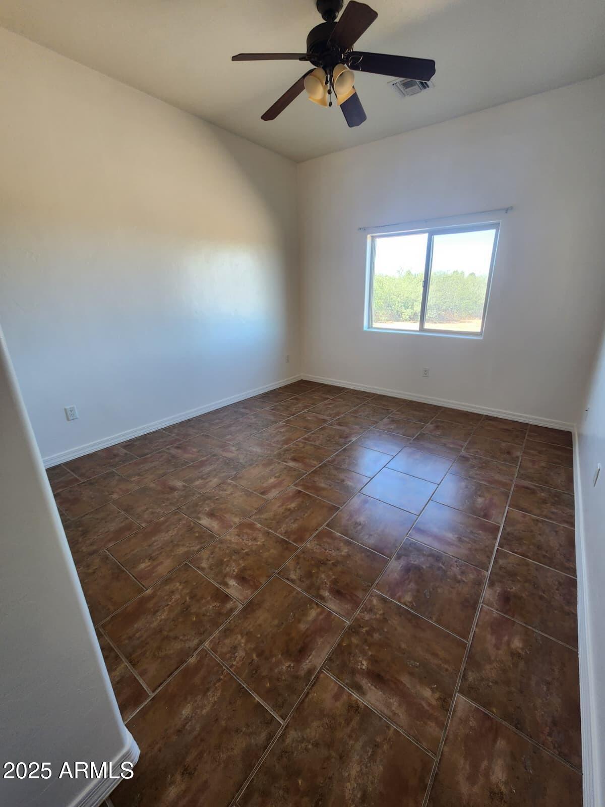 1766 East Golf Course Road Douglas, AZ 85607 - Photo 17 of 29 an empty room with windows and fan