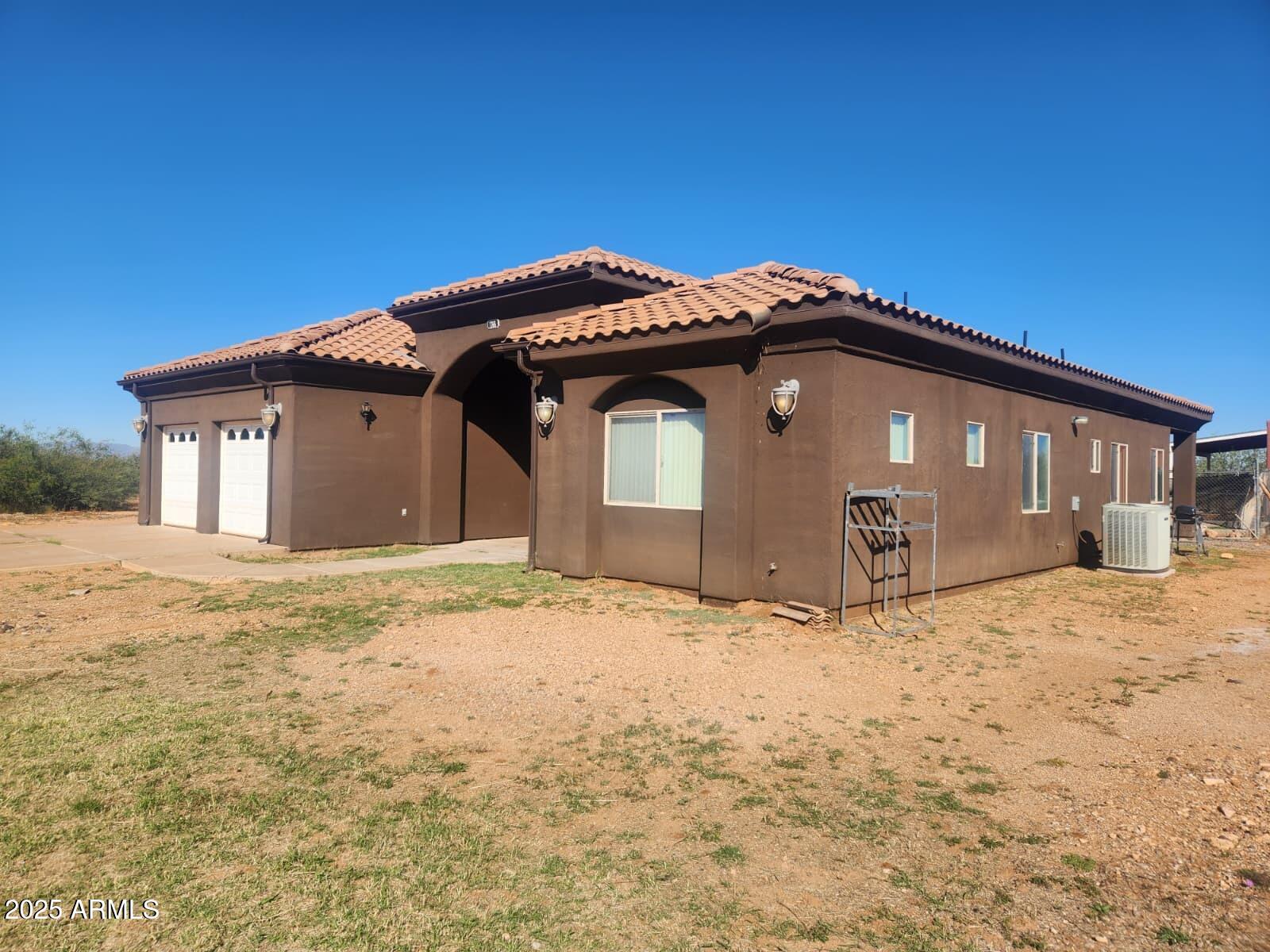 1766 East Golf Course Road Douglas, AZ 85607 - Photo 2 of 29 a front view of a house with a yard