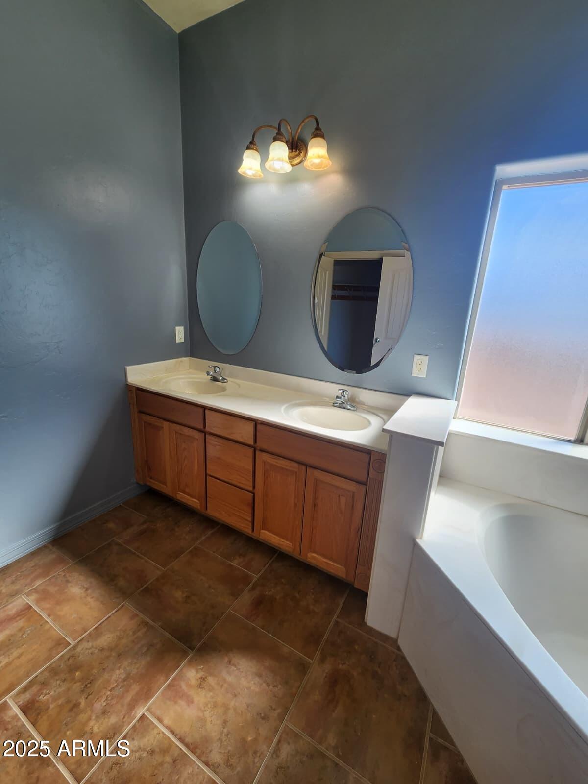 1766 East Golf Course Road Douglas, AZ 85607 - Photo 29 of 29 a bathroom with a double vanity sink and a mirror