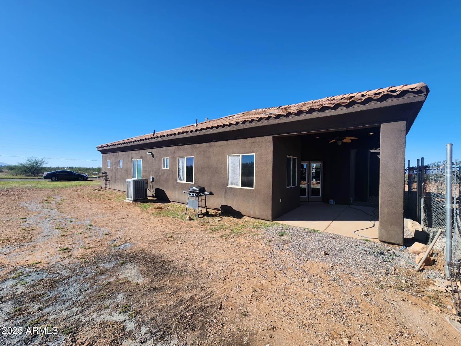 1766 East Golf Course Road Douglas, AZ 85607 - Photo 4 of 29 a view of a house with wooden roof and a large tree