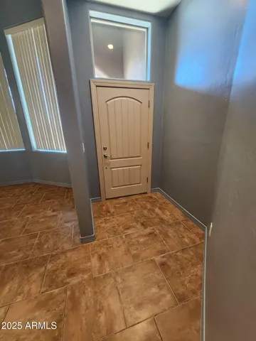 a room with a chandelier and a rug