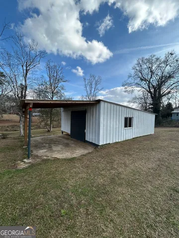 a view of backyard with large trees