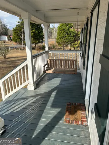 a view of a balcony with wooden floor
