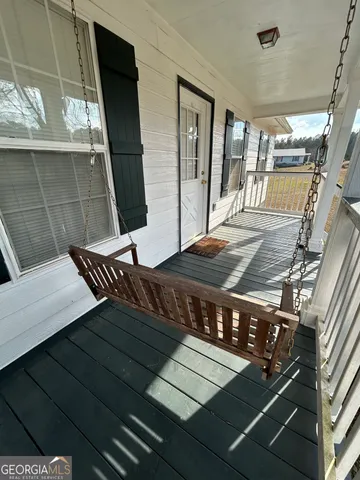 a view of balcony with wooden floor