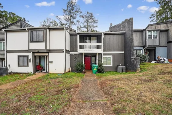 a view of a house with a yard and garage