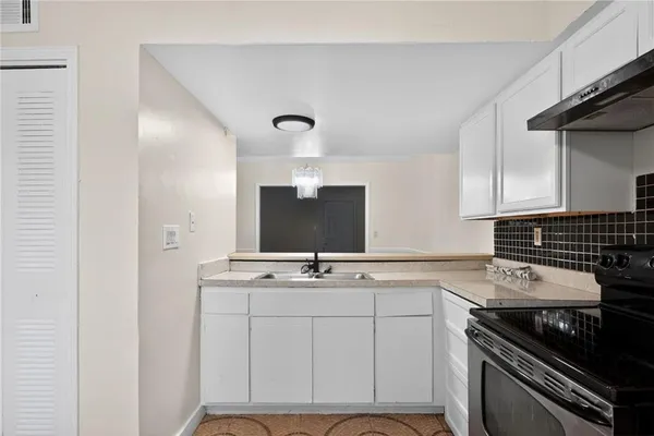 a kitchen with cabinets appliances and a sink